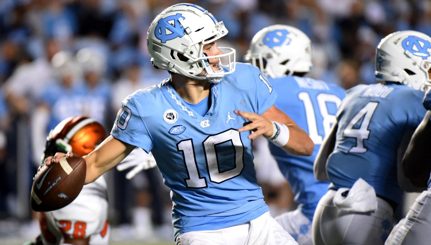 North Carolina Tar Heels quarterback Drake Maye attempts a pass during a college football game.